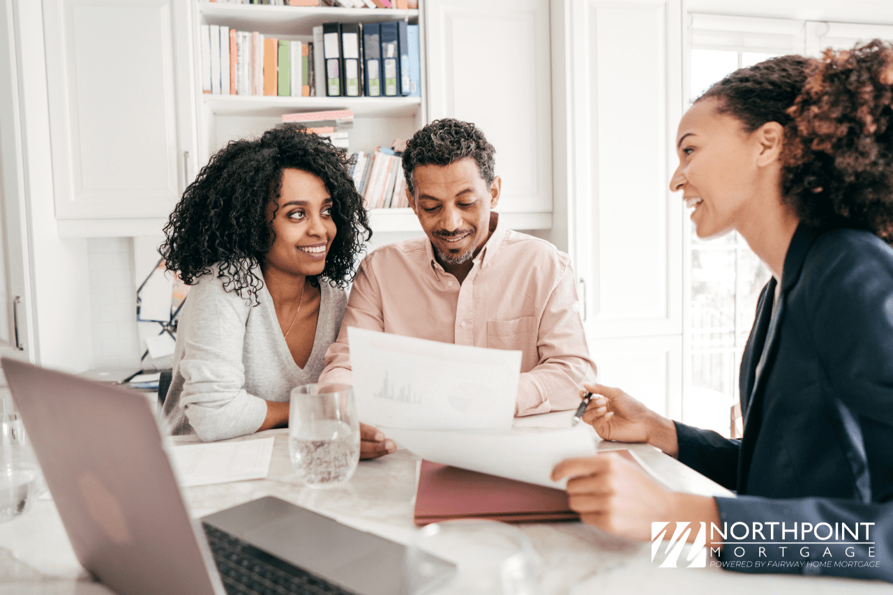 Loan officer meeting with homebuyer and showing checklist