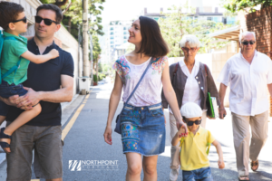 family walking in neighborhood.